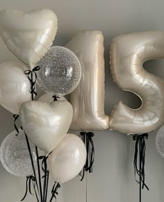 white balloons are arranged in the shape of the letter s