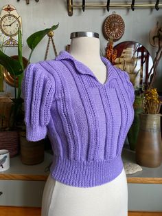 This wonderful seasonal top is just for you. Hand knitted, lilac color, vintage pattern applied exactly. Trendy clothing fashion of the 1930s. Retro Knitted V-neck Tops, Vintage Knitted Cotton Tops, Vintage V-neck Knitted Tops, Vintage Fitted Knit Sweater, Fitted Purple Knit Sweater, Fitted Purple Cotton Sweater, Fitted Vintage Purple Sweater, Fitted Retro Knit Sweater, Retro Fitted Knit Sweater