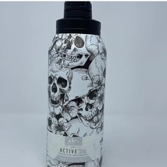 a black and white bottle with skulls on it