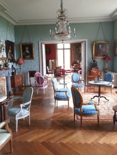 a room filled with furniture and paintings on the walls