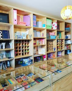 the shelves are filled with many different types of stationery and office supplies in glass cases