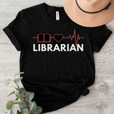 This "School Librarian" shirt is perfect for yourself or to gift to any friend, coworker or family member! It is made of high-quality soft garment and is so comfortable to wear! PRODUCTION TIME: 1-3 business days (Usually 2 days) SHIPPING TIME: 1-5 business days (Usually 3 days)  We do not guarantee delivery times PRODUCT DETAILS:  Our Relaxed Fit Tee is a unisex style.  100% soft cotton (fibre content may vary for different colors).  Light fabric (4.2 oz/yd² (142 g/m.  It's soft, cozy and runs Librarian Tshirts, Library Shirt, Librarian Gifts, Gift For Librarian, Teacher Librarian, Librarian Shirt, School Librarian, Reading Rainbow, Gifts For Librarians