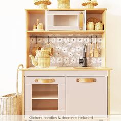 a toy kitchen with an oven, microwave and other items on the shelf above it