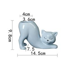 a white cat figurine is shown with measurements for it's body and head