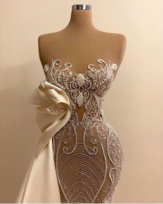 the dress is on display in front of a mannequin's headpiece