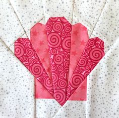 four pieces of pink and white fabric on top of a polka dot table cloth with circles in the center