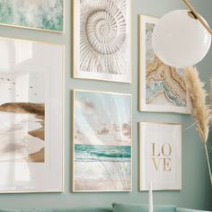 a living room filled with lots of pictures on the wall above a green couch and coffee table