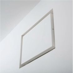 a white square frame hanging on the wall