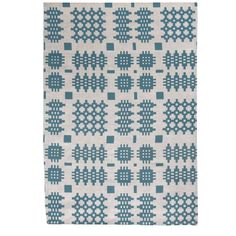 a blue and white rug with small squares on the bottom, in various sizes and colors