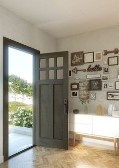 an open door to a room with pictures on the wall and wooden floors in front of it