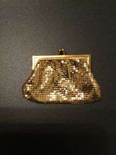 This fabulous clutch style golden mesh bag is a signed piece from Whiting - Davis Co. It has a golden frame.  It has a top thumb turn lock. It is in near mint condition .The inside is clean and in perfect condition and lined with an apricot satin.  Made in U.S. Whiting and Davis stamped. No visible wear. Whiting & Davis remains the recognized leader in metal mesh handbags more than 120 years after its first mesh handbag was produced and continues to attract discerning fans, including actresses, musicians (and you by regularly introducing new styles with an eye toward both trend and functionality. Vintage Memory, Metal Mesh, Change Purse, Coin Purses, Sweet Memories, Mesh Bag, Purse Pouch, Gold Coins, Glasses Case