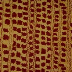 a red and yellow pattern on fabric