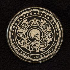 a black and white coin with a skull on it