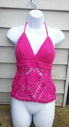 a mannequin wearing a pink crochet swimsuit on top of a white dummy