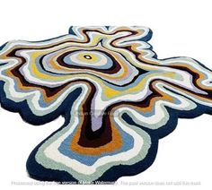 a colorful rug with an abstract design on the bottom and center, in different colors