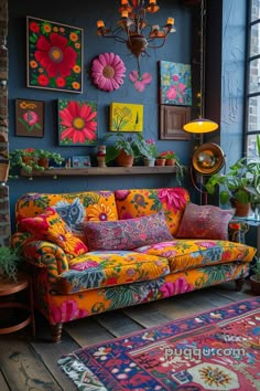 a brightly colored couch sitting in front of a window next to a rug and potted plants