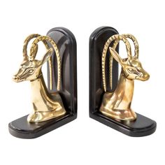 two golden deer bookends on black bases