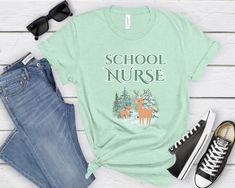 Introducing the School Nurse Winter Scene shirt. Embrace the holiday cheer with this cozy crewneck tailored for school nurses. Perfect tee for the festive season, spirit days, or school celebrations. Treat yourself or delight a special someone with this charming gift! Sizing: - Runs true to retail size, but some people might prefer to size up or down - Please check the size chart added to the pictures - Unisex design is comfortable and flattering for both men and women - Fit style is retail fit* School Nurse Shirt, School Clinic, Spirit Days, Scene Shirt, Nursing School Gifts, Unisex Looks, School Celebration, School Nurse, Nurse Christmas