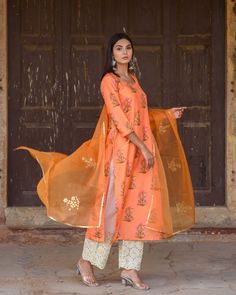 Orange Silk Printed Kurta Suit Set with Organza Dupatta The set consists of silk printed kurta round neck, 3/4th sleeves teamed with contrast gold chikan palazzo pants and an organza dupatta with handcraft gota motif Kurta Length-45 inches (can be customised) Pant Length- 36 inches (can be customised) Dupatta - 2.5 meters Work-Print Work Color-Orange Top Fabric -Silk Bottom Fabric - Chikan Dupatta Fabric-Organza Sleeves - 3/4th Sleeves Neck-Round Washing Care-Dry Clean Suits Usa, Organza Sleeves, Indian Bridal Dress, Anarkali Kurta, Silk Bottoms, Silk Kurta, Organza Dupatta, Orange Fabric, Indian Ethnic Wear