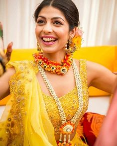 a woman in a yellow outfit smiles and poses for the camera