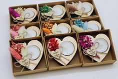 a box filled with lots of different types of heart shaped tea light candles in it