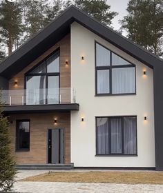 a large white and black house with lots of windows