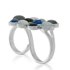 Lisa Bridge gray and white moonstone bubble double-finger ring with faceted dyed blue chalcedony, set in sterling silver. Inspired by sea foam carried to shore on the crest of waves, this fashion-forward geometric ring is designed to be worn over two fingers for a stylish statement in soft, cool hues. Ring is a size 7 with one adjustable silver band. 
Complement with matching bracelet- as available. 
11440724 

Part of the San Juans Collection by Lisa Bridge, named for the chain of islands off o Modern Adjustable Moonstone Sterling Silver Ring, Modern Adjustable Moonstone Gemstone Ring, Modern Adjustable Moonstone Ring, Modern Blue Moonstone Gemstone Ring, Modern Blue Moonstone Ring, Modern Silver Rings With Natural Stones, Modern Silver Chalcedony Jewelry, Double Finger Ring, Bubble Ring