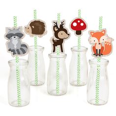 woodland animal cupcake toppers in glass vases with green and white straws