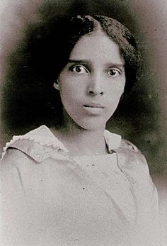 an old black and white photo of a woman with eyes wide open, looking at the camera