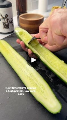 someone cutting up a cucumber with a knife