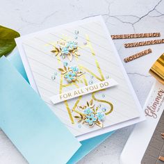 a close up of a card on a table with some scissors and other crafting supplies