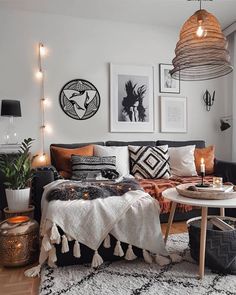 a living room filled with lots of furniture and pictures on the wall above it's coffee table