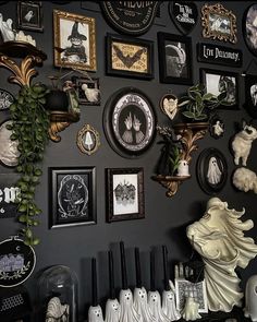 there are many pictures on the wall with black and white decorations around them, as well as an assortment of figurines