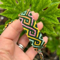 Hand-knotted friendship bracelet, made from soft cotton thread.  For this bracelet, I used a twisting diamond flame pattern and shades of dark green, pink, yellow, mint, and orange.  Each end is finished with a twist for tying onto your wrist. Approximate measurements & other details: Knotted/main section: 6.0" (15cm) Total length, including ties: 17" (43cm) Width: 5/8" (1.5cm) Closure: adjustable tie-on with twisted ties 100% cotton Made by me in the USA This bracelet is ready-to-ship -- you will receive the exact bracelet you see pictured.  (I try my best to photograph the colors accurately, but it may look slightly different on your computer than in real life). Want to see more?  Just click here: http://www.BrightVillage.Etsy.com Follow me on Instagram - @brightvillagebracelets SKU: #10 Cheap Orange Hand-strung Friendship Bracelets, Affordable Orange Hand-strung Friendship Bracelets, Cheap Hand-strung Yellow Friendship Bracelets, Cheap Hand-strung Orange Friendship Bracelets, Shades Of Dark Green, Colors Of Green, Flame Pattern, Cool Friendship Bracelets, String Bracelet