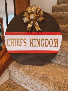 a sign that says chefs kingdom with a bow on it sitting on the carpeted stairs