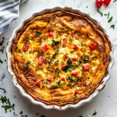 a quiche in a white dish on a marble table