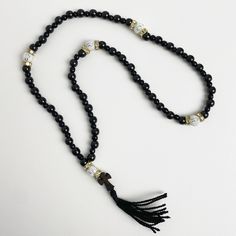 "50 beads rosary made of black jasper. The Orthodox prayer beads are crafted from the natural stone \"Gagat,\" renowned since ancient times for its protective and healing properties. It is alternatively known as \"Black Jasper\" or \"Black Amber.\" Splitting beads from the wood species \"Boxwood\" - which is one of the hardest wood species. Orthodox black rosary will be an amulet and protector of its owner, used for counting the prayers read or other ritual actions, preserving attention and concentration, the task of rhythm, massage nerve endings located on the fingertips, associated with the nervous system of man.  ★ Length of the rosary: 13.78 in (35 cm) ★ Bead diameter: 0.23~0.11 in (6~3 mm) ★ Number of beads: 50+5 pcs (50 gagat beads, 5 boxwood beads) ★ Dimensions of the cross: 0.69 in Spiritual Black Onyx Beaded Necklace, Black Spiritual Beaded Necklaces With Polished Beads, Spiritual Black Beaded Necklace With Gemstones, Adjustable Rosary With Polished Beads For Meditation, Adjustable Polished Beads Rosary For Meditation, Black Spiritual Beaded Necklace With Round Beads, Spiritual Black Beaded Necklaces With Round Beads, Black Polished Beads Necklace For Healing, Black Spiritual Beaded Necklaces