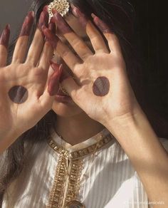 a woman holding her hands over her eyes