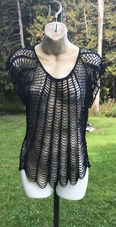 This vintage Debbie Shuchat black beaded with black netting design shirt is slightly used in good condition. Black beadwork threaded through a black netting base with all original material. Measurements: Label Reads: Large Height 25" inches Across the Chest:  19" inches Across the Back: 19" inches Across the Shoulders: 21" inches We do our best to take live, clear and as many pictures as possible to guarantee what you see is what you will receive. Any issues with the purchased product(s) must be Black Crochet Top With Short Sleeves For Summer, Fitted Black Mesh Top For Festival, Black Fitted Mesh Top For Festivals, Black Stretch Beach Blouse, Stretch Black Beach Blouse, Beach Stretch Black Blouse, Black Stretch Crochet Top For Party, Beaded Netting, Beading Netting