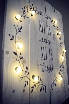 a sign with lights on it that says, all is calm and all is bright