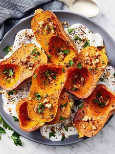 baked delicacy sweet potatoes on a plate topped with nuts and parmesan