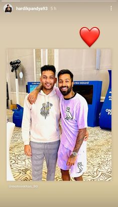 two men standing next to each other in front of a heart shaped photo on a cell phone