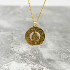 Crafted for the discerning Muslim woman, the Diwani Ayatul Kursi Necklace is a true masterpiece of Islamic jewelry. Made from high-quality 925 sterling silver and elegantly plated with 18K gold, this pendant is a blend of sophistication and faith. The intricate design featuring the Ayatul Kursi from the Quran adds a spiritual touch to any outfit. Whether worn as a daily reminder of faith or as a special gift, this necklace embodies both style and devotion. Elevate your jewelry collection with this symbolic piece that celebrates both beauty and faith in a subtle and elegant manner. Size of Pendant: 1x1" | 2.5x2.5 cm Weight of Pendant (Without Silver Chain): 0.14 oz | 3.8 gr Material of Pendant: 18K gold plated on Hypoallergenic 925 sterling silver. Length of Chain : 14 in - 35 cm | 16 in - Traditional Tarnish Resistant Pendant Jewelry, Amulet Style Engraved Necklace For Anniversary, Symbolic Necklace With Polished Finish As Gift, Symbolic Necklace With Polished Finish For Gift, Traditional Pendant Necklace Tarnish Resistant, Engraved Amulet Necklace For Anniversary, Ceremonial Polished Pendant Necklaces, Gold Plated Necklaces With Intricate Design For Gift, Ceremonial Pendant Necklace With Polished Finish