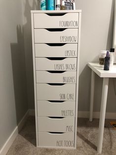 a tall white cabinet with lots of drawers