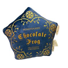 a blue and gold pillow with the words chocolate frog on it's side, sitting in front of a white background