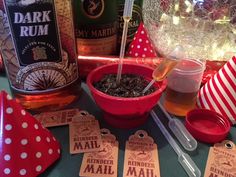 a table topped with lots of bottles of alcohol and paper hats on top of it