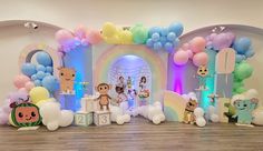 an entrance to a children's birthday party decorated with balloons and animals on it