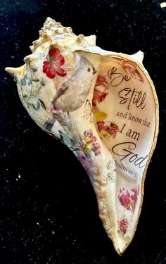 the shell has been decorated with flowers and words