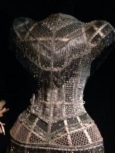 the back of a corset made out of glass beads