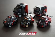 four toy cars sitting next to each other on top of a black surface with the words advan written above them